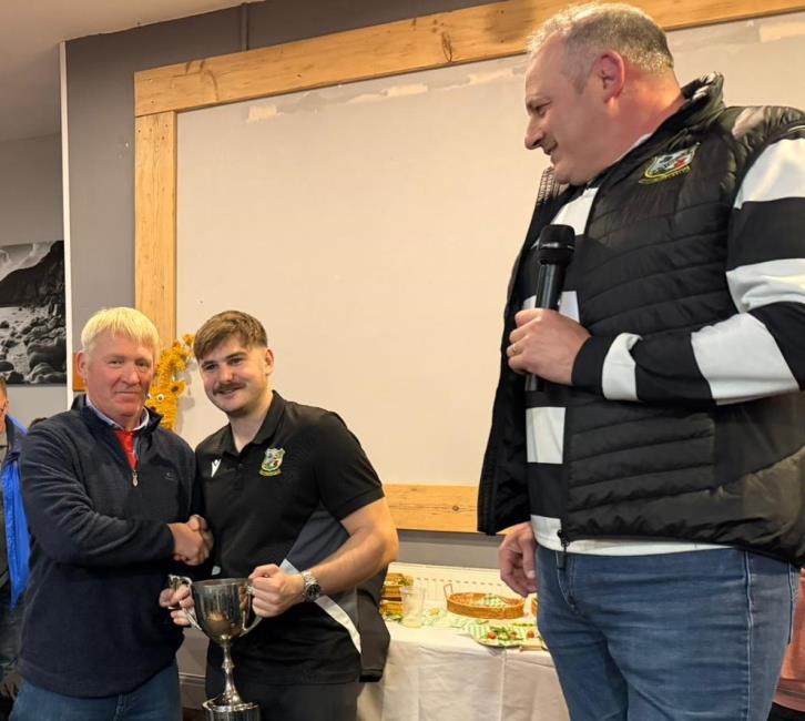 Quins skipper Ben Hathaway receives the Eric Brown Cup from Richard Jelley